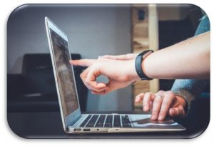 Person pointing at computer