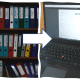 File folders, arrow, invoice on computer screen